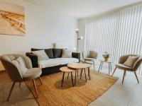 a living room with a couch and two chairs and a table at Apartment Rodenbach by Interhome in De Haan