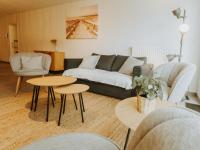 a living room with a couch and a table and chairs at Apartment Rodenbach by Interhome in De Haan