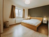 a bedroom with a bed and a window at Apartment Rodenbach by Interhome in De Haan