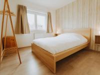 a bedroom with a large bed and a ladder at Apartment Rodenbach by Interhome in De Haan