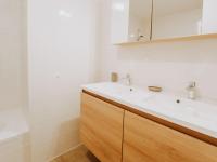a bathroom with a white sink and a mirror at Apartment Rodenbach by Interhome in De Haan