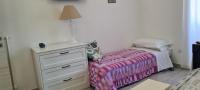 A bed or beds in a room at La Casetta di Meta
