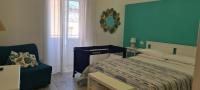 A bed or beds in a room at La Casetta di Meta