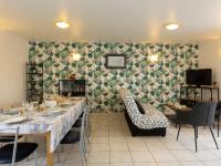 a dining room with a long table and chairs at Holiday Home Coquelicot by Interhome in Saint-Méloir-des-Ondes