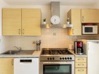 a kitchen with a stove top oven next to a sink at Holiday Home Coquelicot by Interhome in Saint-Méloir-des-Ondes