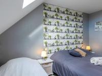 a bedroom with two beds and a wall with potted plants at Holiday Home Coquelicot by Interhome in Saint-Méloir-des-Ondes