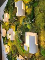a wall with green moss and white shapes at Hôtel Restaurant BO &amp; MIA in La Baule