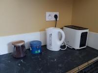 a counter top with two coffee machines on it at Au ptit Manoir in Montbert