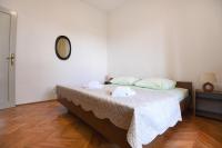 Posteľ alebo postele v izbe v ubytovaní Apartmani Erna