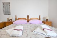 Posteľ alebo postele v izbe v ubytovaní Apartmani Erna