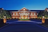 a large red brick building with a driveway at Westfields Marriott Washington Dulles in Chantilly