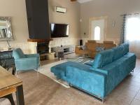 a living room with a blue couch and chairs at Villa Emma 10 &#47; 12 personnes in Grignan