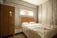 a bedroom with a large white bed and a cabinet at The New Season Apart in Istanbul