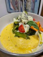 a white bowl of food with vegetables on a table at Садиба Бабина Лоза in Lisove