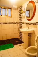 a bathroom with a sink and a toilet and a mirror at Ding Ding Homestay in Jinhu