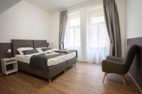 a bedroom with a large bed and a chair at Residence St Havel Prague Old Town in Prague