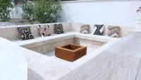 a bench with pillows and a wooden box on it at Villa luxe Oasis de Satteva in L&#39;Isle-sur-la-Sorgue