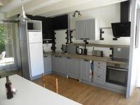 a kitchen with white cabinets and a counter top at les figuiers et les rosiers proche puy du fou in Saint-Germain-de-Prinçay