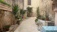 a courtyard with potted plants in a stone building at historic authentic atmosphere - high-end luxury décor in Le Cannet