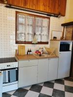 a kitchen with white cabinets and a counter top at Le gîte du Brouage in Chauny