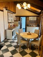 a kitchen with a table and chairs in a room at Le gîte du Brouage in Chauny