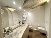 a bathroom with a sink and a toilet and a mirror at SAN TEODORO PUNTA EST FANTASTICO TRILOCALE VISTA MARE in Capo Coda Cavallo