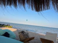 a view of the beach with chairs and the ocean at Mangroovy Seafront condo - Great Kite Surfing in Hurghada