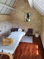 a bedroom with a bed in a stone wall at Les Pierres Lotoises - gîte les grandes pierres in Reilhaguet