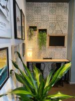 a plant in front of a wall with a counter at The Originals Boutique, Hôtel d&#39;Angleterre, Le Havre, centre, plage in Le Havre