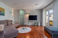 Televízia a/alebo spoločenská miestnosť v ubytovaní Apartments Liam