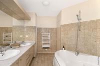 a bathroom with two sinks and a tub and a shower at NOCNOC - Le Pargamin - Large duplex Place Saint-Pierre in Toulouse