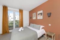a bedroom with a large bed and a window at NOCNOC - Le Pargamin - Large duplex Place Saint-Pierre in Toulouse