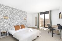 a bedroom with a bed and a wall with a window at NOCNOC - Le Pargamin - Large duplex Place Saint-Pierre in Toulouse