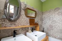 a bathroom with two sinks and a mirror at Propriete spacieuse a Saint Trojan Vue mer in Saint-Trojan-les-Bains