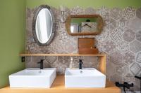 a bathroom with two white sinks and a mirror at Propriete spacieuse a Saint Trojan Vue mer in Saint-Trojan-les-Bains
