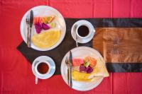 a table with two plates of food and two cups of coffee at Bamboo Ubud Hostel in Ubud