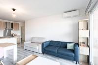 a living room with a blue couch and a kitchen at L41 Suite Paladium parking 8pax 4rooms balcony WIFI&#47;AC in Nice