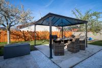 a gazebo with a table and chairs under it at Charmant pavillon bordelais (logement entier) in Saint-Médard-en-Jalles