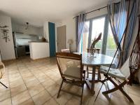 a kitchen and dining room with a table and chairs at small house 6p in bormes, quiet , hill-view in Bormes-les-Mimosas