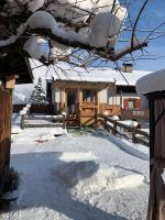 a yard covered in snow with a house at Appartement Waldmoos in Ellmau
