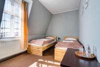 Łóżko lub łóżka w pokoju w obiekcie Hotel Sowa