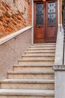 a set of stairs leading to a wooden door at Hotel Casa Boccassini in Venice