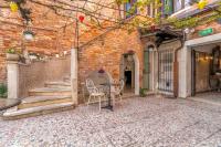 a table and chairs in front of a brick building at Hotel Casa Boccassini in Venice