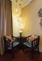 a room with two chairs and a table and a chandelier at Yunju House in Jiaoxi