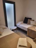 A bed or beds in a room at Roses Casc Antic S L Sabater 1