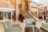 a lobby with chairs and stairs in a building at NH Atlanta Rotterdam Hotel in Rotterdam