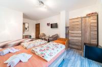 A bed or beds in a room at Penzión Zunama