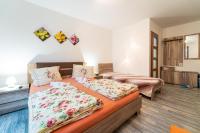 A bed or beds in a room at Penzión Zunama