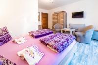 A bed or beds in a room at Penzión Zunama