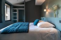 a bedroom with a large bed with blue walls at Château de Pierreclos in Pierreclos